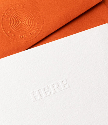 Close-up of the Kit of Here embossed logo and letterpress card showing premium paper texture and detailing.